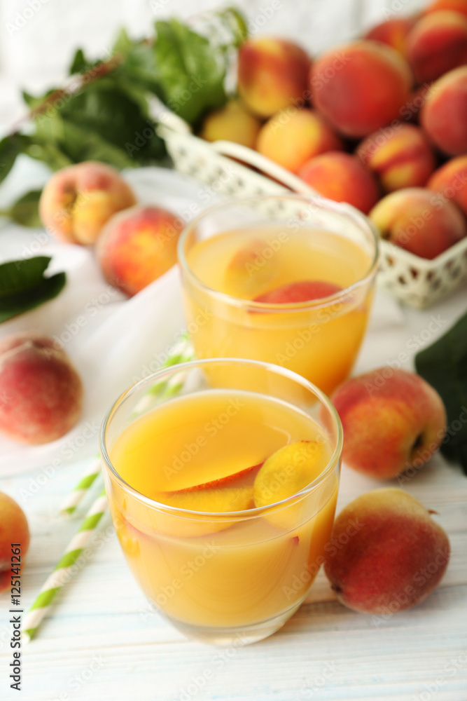 Glasses of peach juice on white wooden table Glasses of peach juice on white wooden table