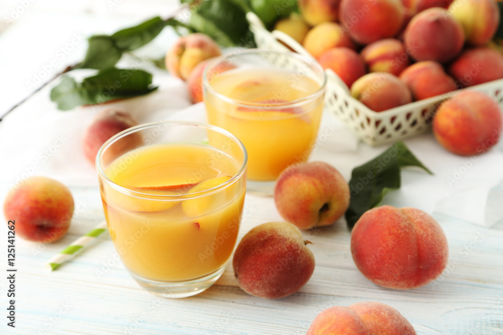 Glasses of peach juice on white wooden table Glasses of peach juice on white wooden table