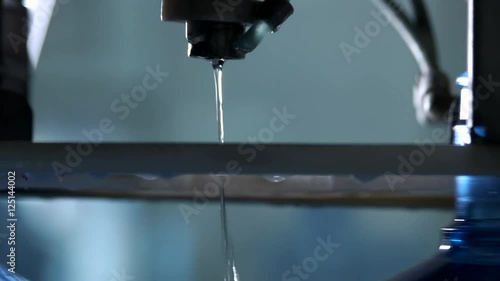 Water fills up a bottle. Stream of liquid. New conveyor at the plant. Gallons of purified water.