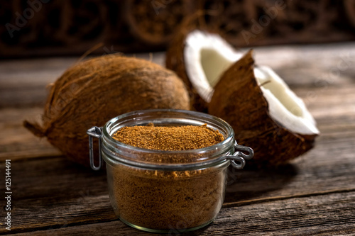 Coconut palm sugar on rustic wooden background