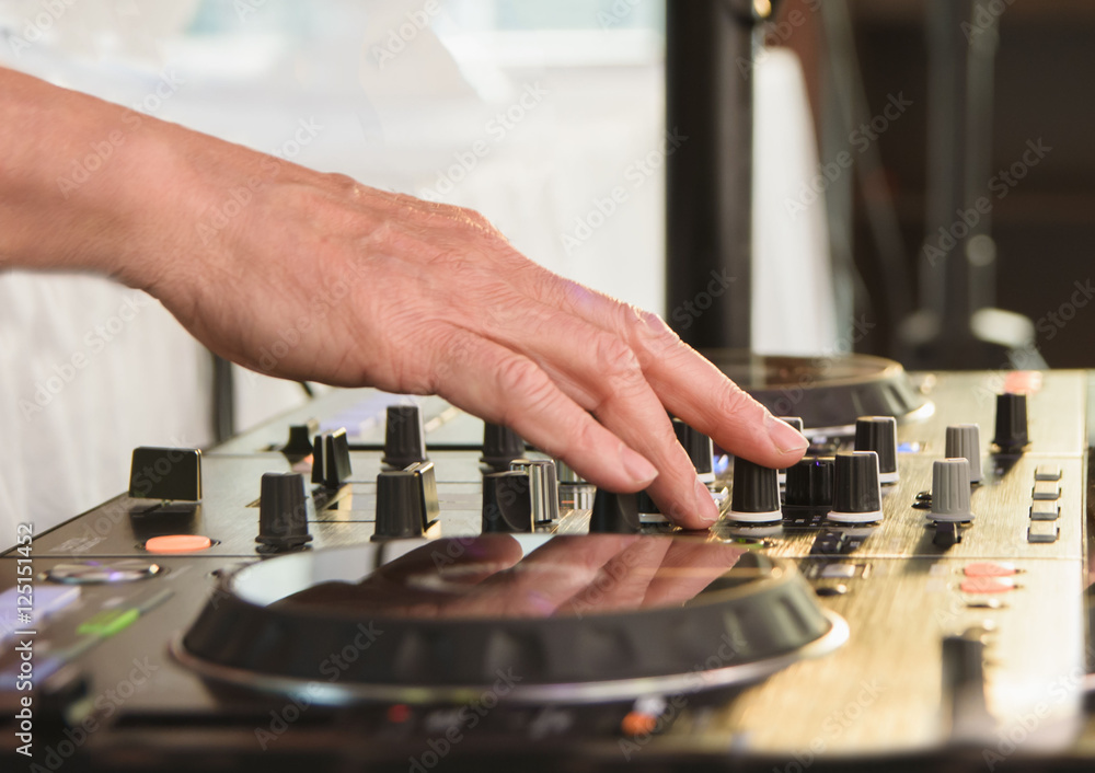 DJ behind the decks spinning music close up DJ behind the decks spinning music close up