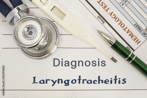 Diagnosis Laryngotracheitis. Stethoscope, electronic thermometer, patient blood test results lying on medical history, which is written diagnosis Laryngotracheitis. Concept for internal medicine, ENT photo