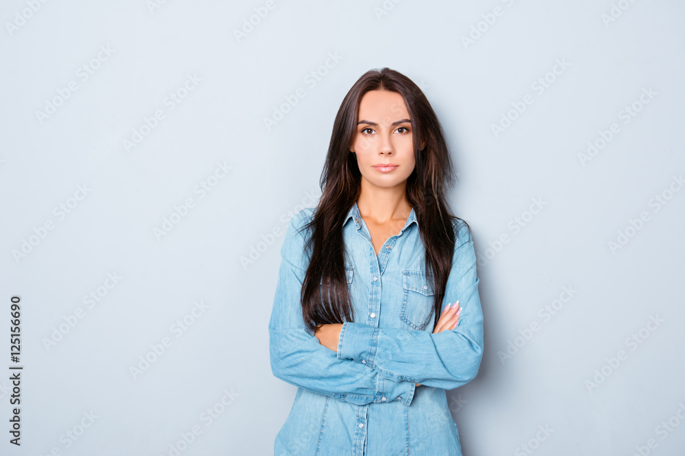 Young happy woman with crossed hands isolated on gray background Young happy woman with crossed hands isolated on gray background