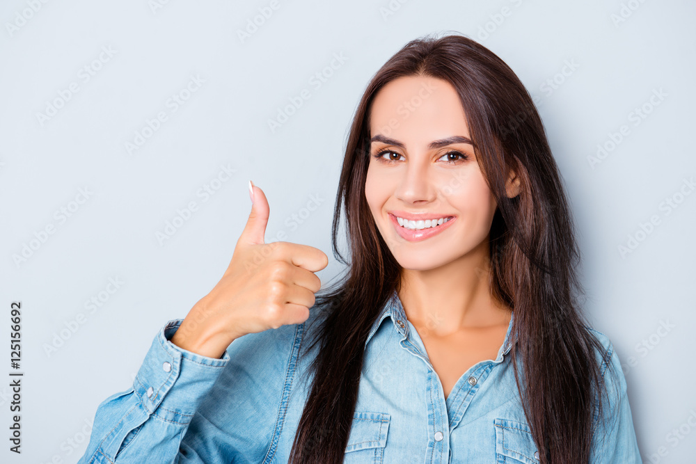 Pretty woman with beaming smile showing thumb up Pretty woman with beaming smile showing thumb up
