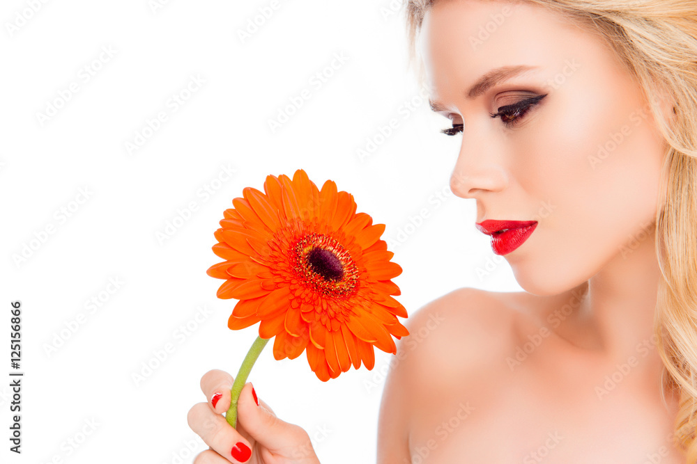 Young pretty sensual  blonde holding gerbera flower