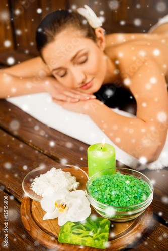 Happy young woman relaxing with spa cosmetics, xmas concept