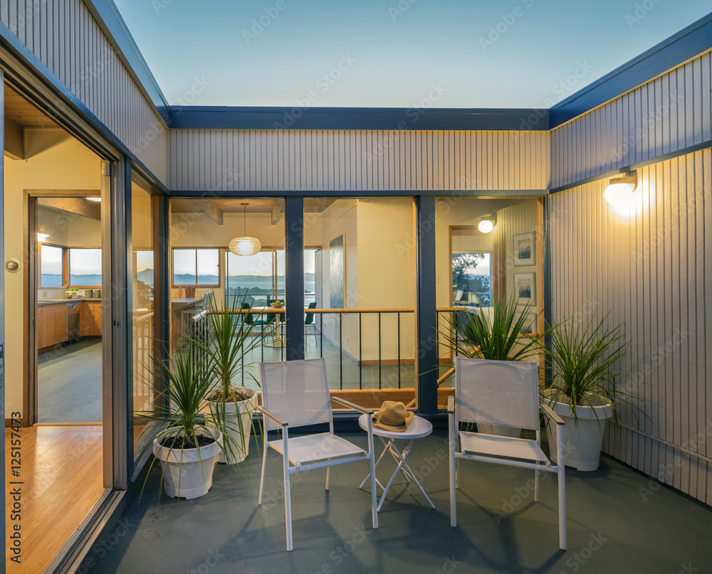 Fototapeta premium Sliding doors within open Courtyard at twilight. 