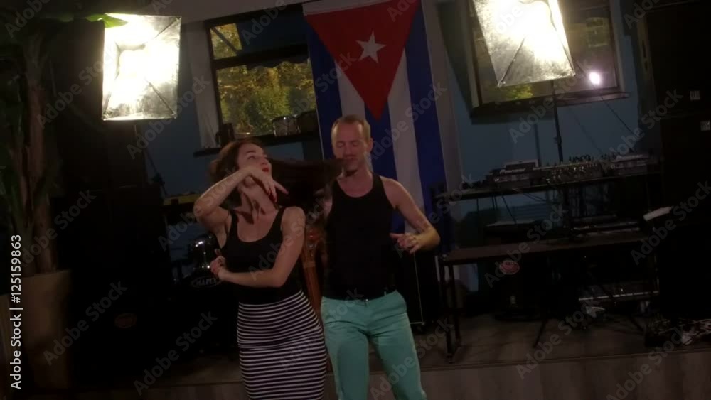 Dancing man dodges from long hair of his female partner, slowmo