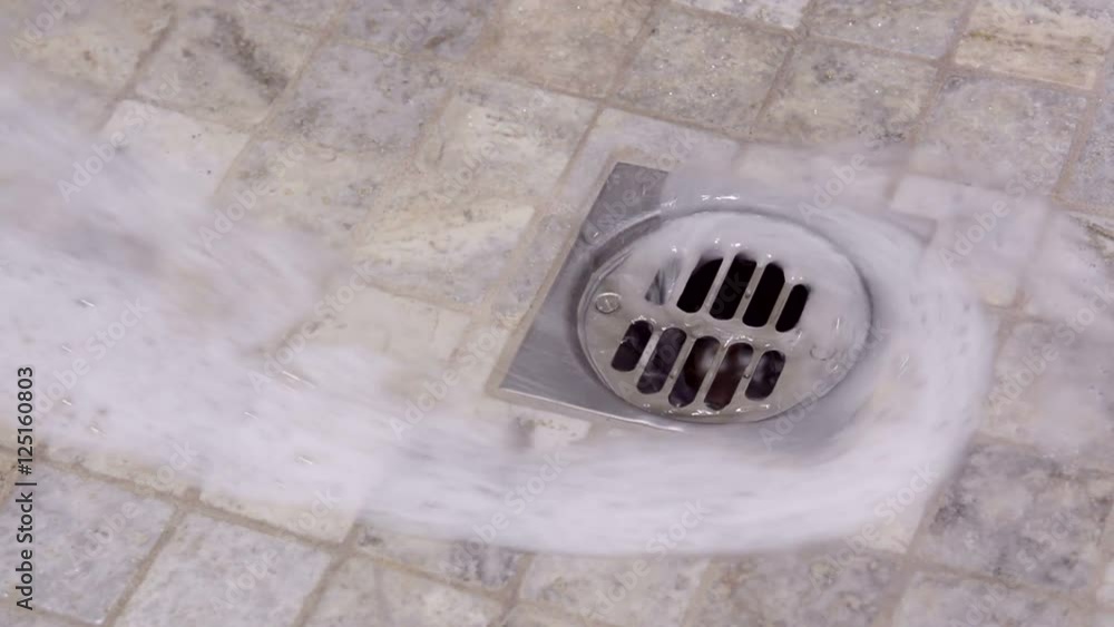 Soapy shower water swirls down a basin drain. Good for hygiene or environmental inferences. Soapy shower water swirls down a basin drain. Good for hygiene or environmental inferences.