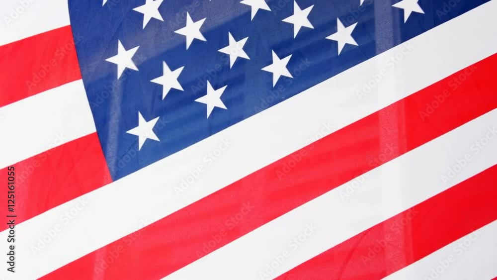 An American flag flowing in front of a window symbolizing freedom, patriotism and national pride.. An American flag flowing in front of a window symbolizing freedom, patriotism and national pride..