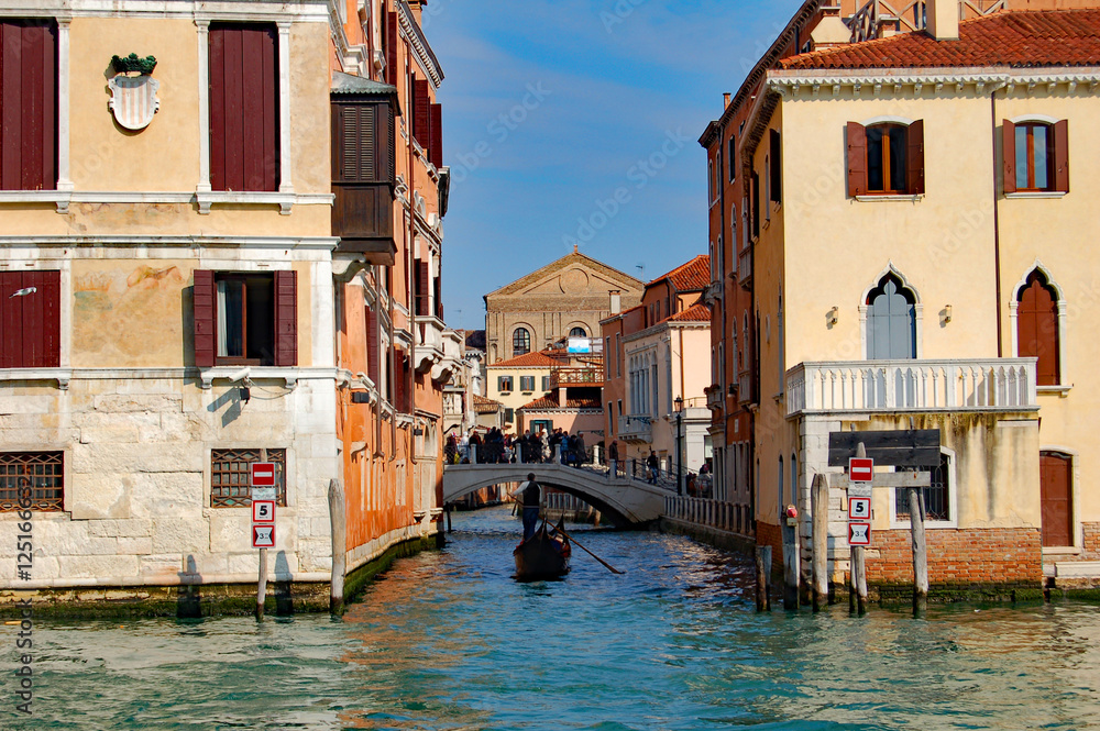 Venice side canal with gondola in frame