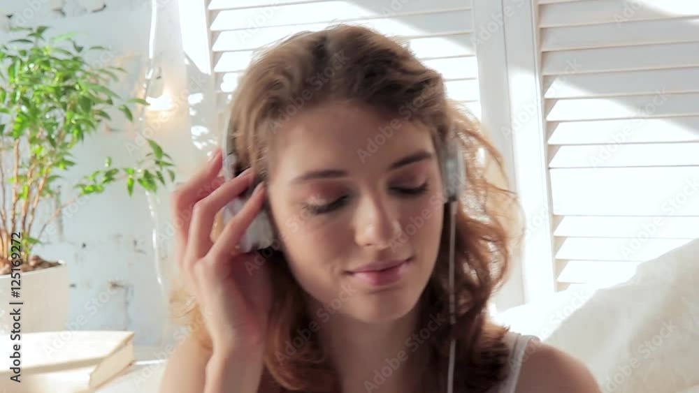 Young happy woman enjoying music with headphones on a sunny morning Young happy woman enjoying music with headphones on a sunny morning