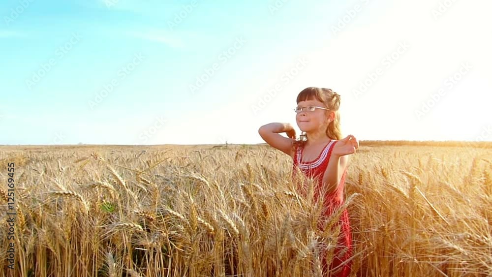 Little girl playing in the wheat field at sunset.Slow motion,high speed camera Little girl playing in the wheat field at sunset.Slow motion,high speed camera
