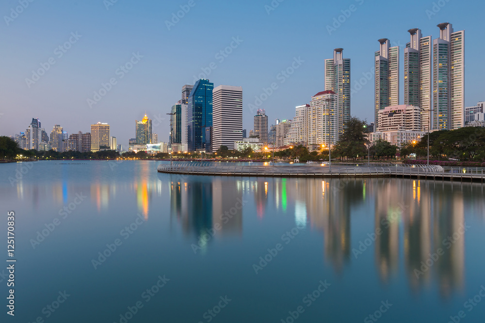 Modern office building with water reflection with clear blue sky background, Bangkok Thailand