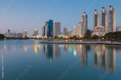 Modern office building with water reflection with clear blue sky background, Bangkok Thailand © pranodhm