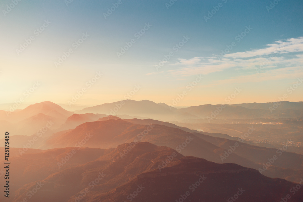 View of morning Montserrat mountains with haze and blue sky