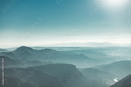 Canvas Print View of morning Montserrat mountains with haze and teal sky