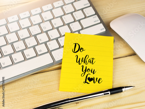 Do what you love on sticky note on work wooden desk
