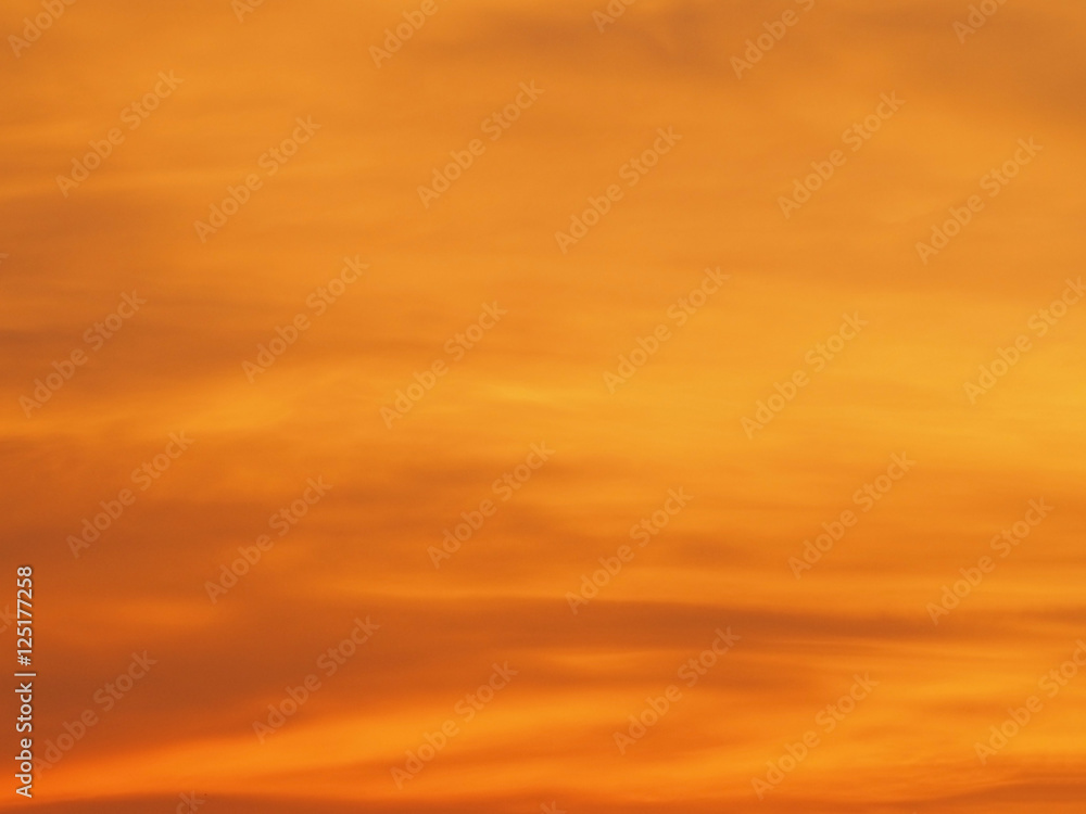 Blur beautiful bright orange sky at sunset sunrise background. Abstract orange sky. Dramatic golden sky at the sunset background.