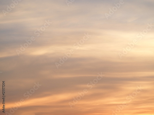 Cool soft orange, purple and blue sky with clouds in background, Pastel tone.