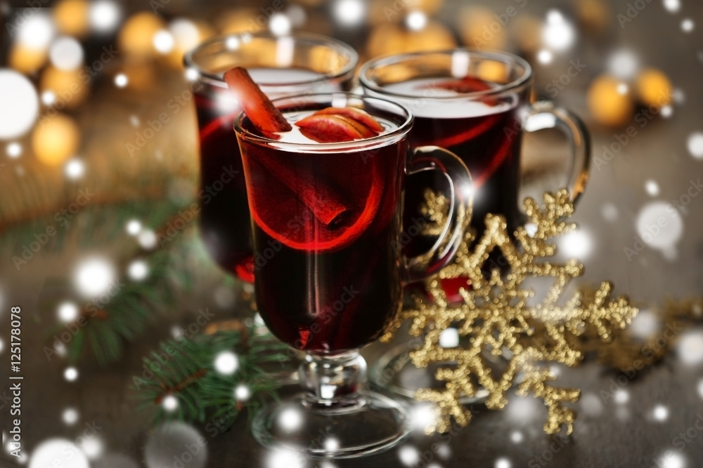 Glasses of delicious Christmas mulled wine, closeup. Snowy effect, Christmas concept. Glasses of delicious Christmas mulled wine, closeup. Snowy effect, Christmas concept.
