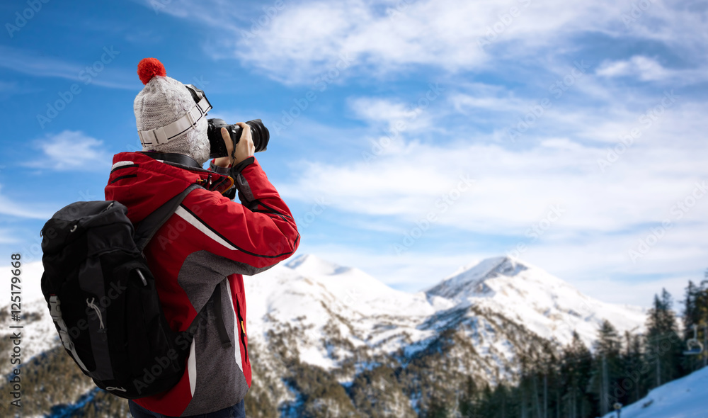 Woman in ski suit takes picture