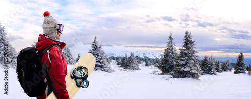 Woman with snowboard on mountain