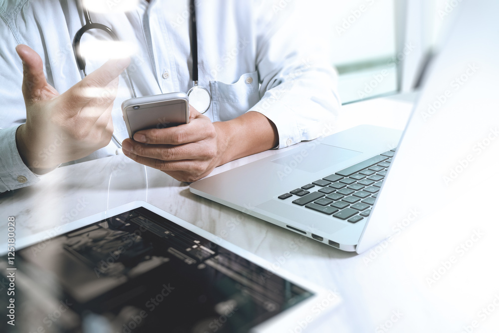 Medicine doctor hand working with modern digital tablet and lapt Medicine doctor hand working with modern digital tablet and lapt