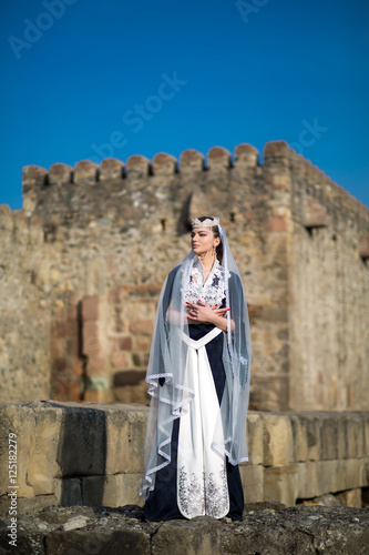 beautiful young Georgian girl near old castle © muzhchil