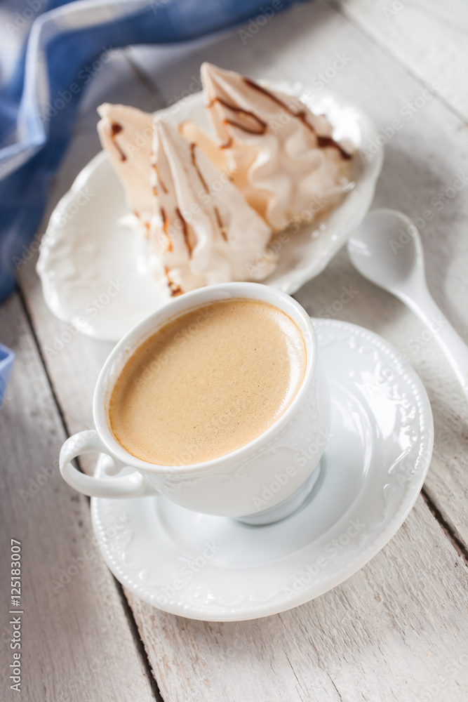 coffee and cakes of meringue on a table, selective focus coffee and cakes of meringue on a table, selective focus