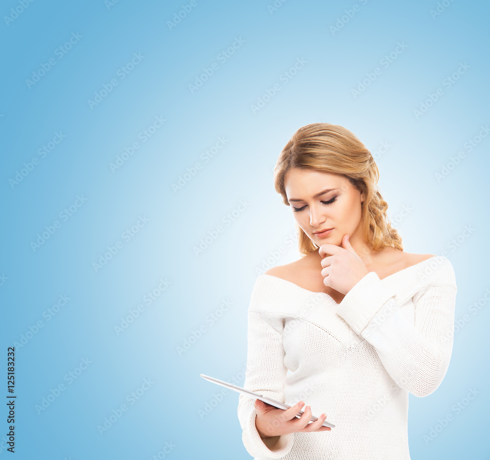 Young blond woman holding a tablet computer Young blond woman holding a tablet computer