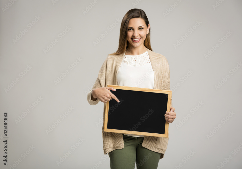 Woman showing something on a chalkboard Woman showing something on a chalkboard