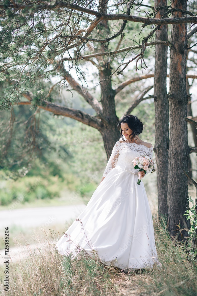 Beautiful bride outdoors in a forest. Beautiful bride outdoors in a forest.