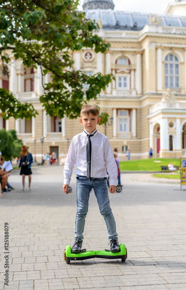 Fototapeta premium Stylish young boy riding a hover board