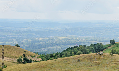 Transalpina road with hills covered with green grass, Parang Mountains