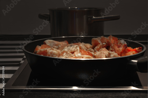 Frying pan with chicken meat