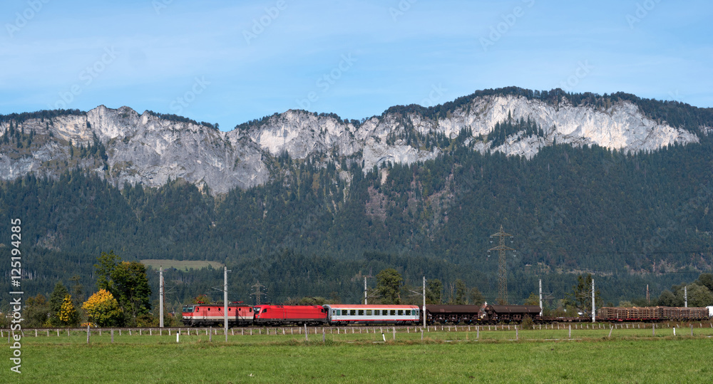 Commercial red train travels to the Austrian Alps. Commercial red train travels to the Austrian Alps.