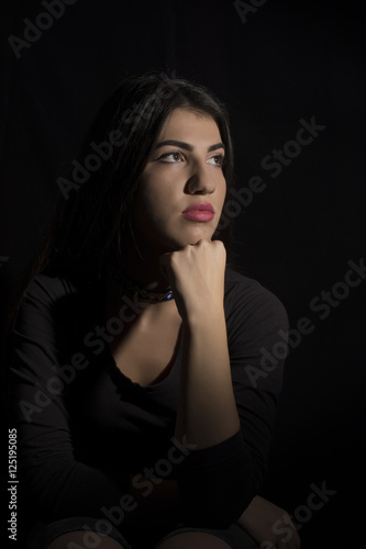 Young woman ,studio portrait on black background