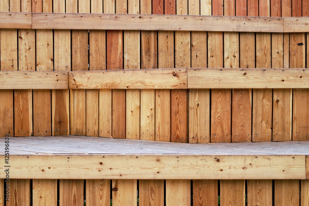 Unusual tiered wooden bench consisting of vertical and horizontal wooden planks Unusual tiered wooden bench consisting of vertical and horizontal wooden planks