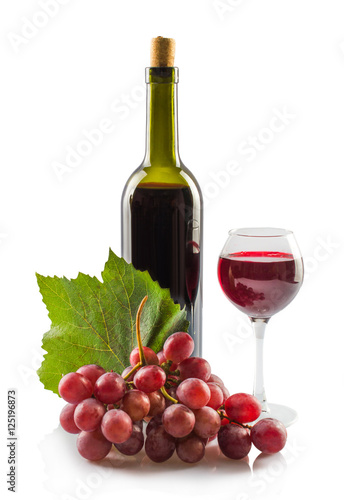Bottle of red wine and a glass. leaves of grapes a bunch of grapes. On white, isolated background.