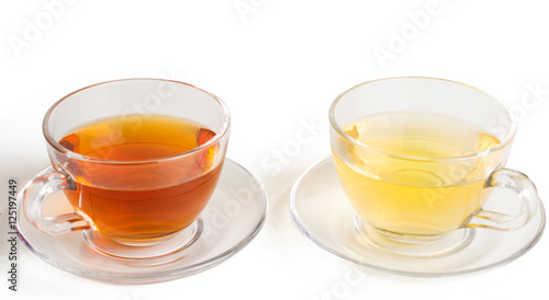 Green and black tea in a glass cup. On white, isolated background.