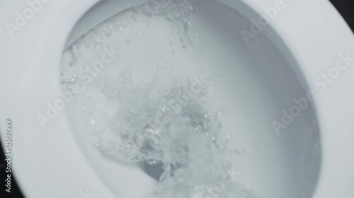 Flushing toilet. Drain the water into white toilet