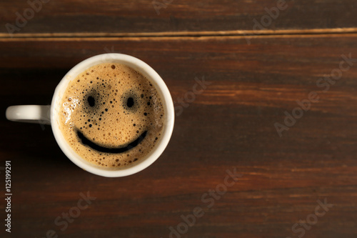 Good morning coffee smile cup on wooden background