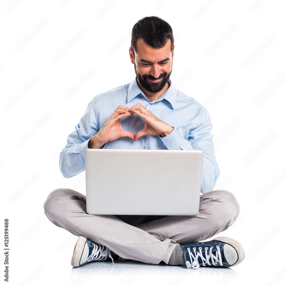 Man with laptop making a heart with his hands Man with laptop making a heart with his hands