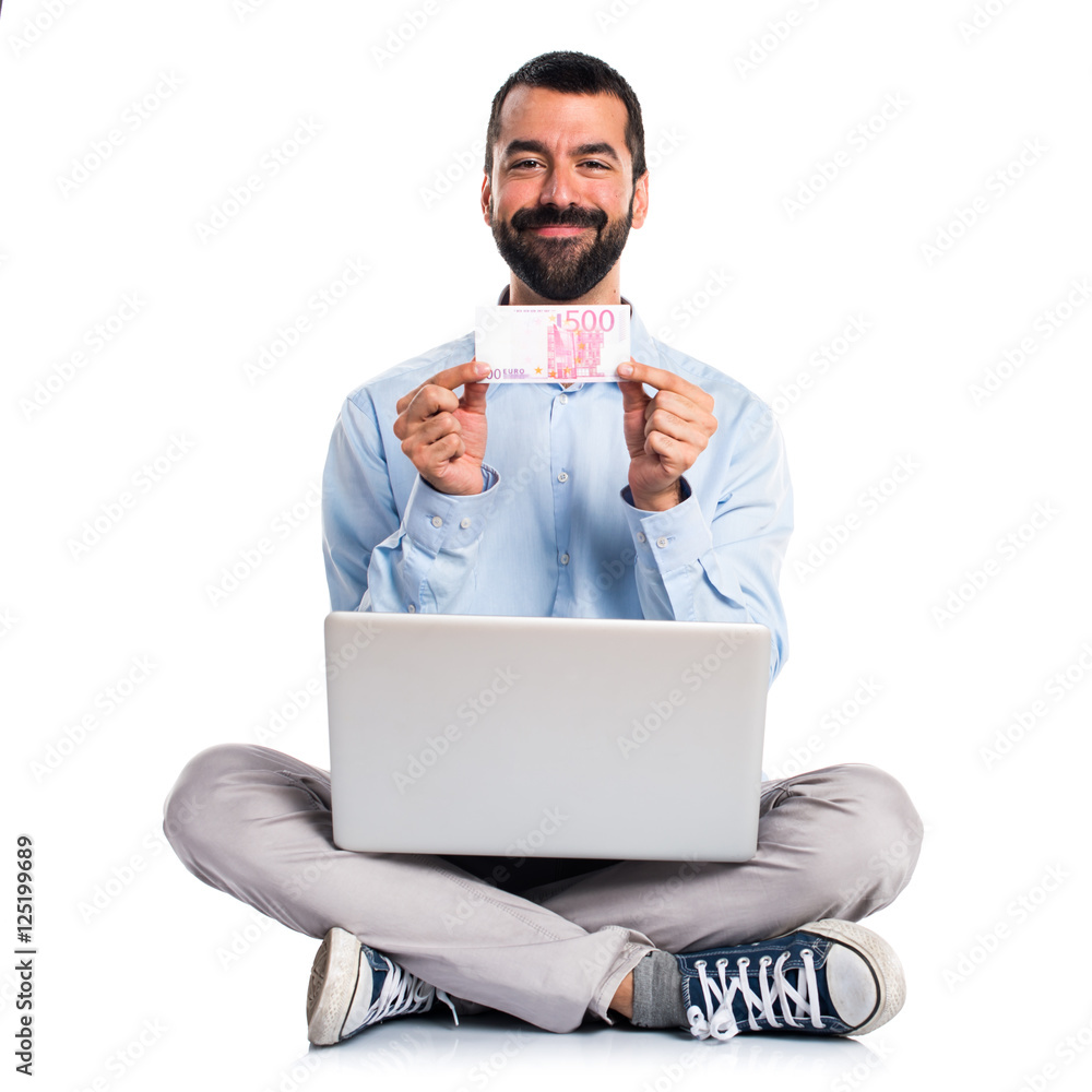 Man with laptop taking a lot of money Man with laptop taking a lot of money