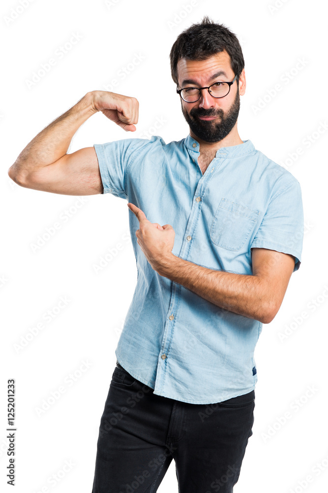 Handsome man with blue glasses making strong gesture Handsome man with blue glasses making strong gesture