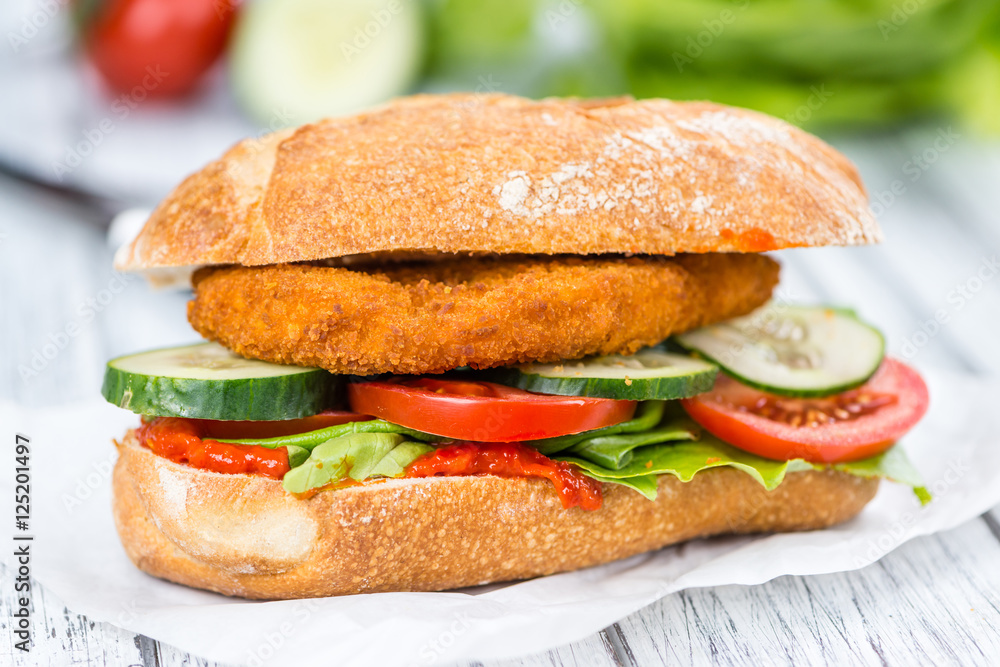 Chicken Schnitzel on a bun (selective focus) Chicken Schnitzel on a bun (selective focus)