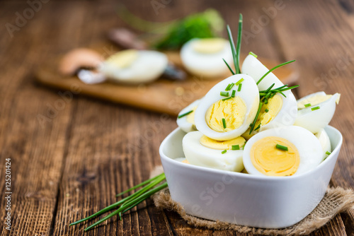 Halved Eggs on wooden background