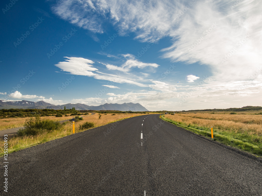 Empty road with a blue cloudy sky, Iceland Empty road with a blue cloudy sky, Iceland