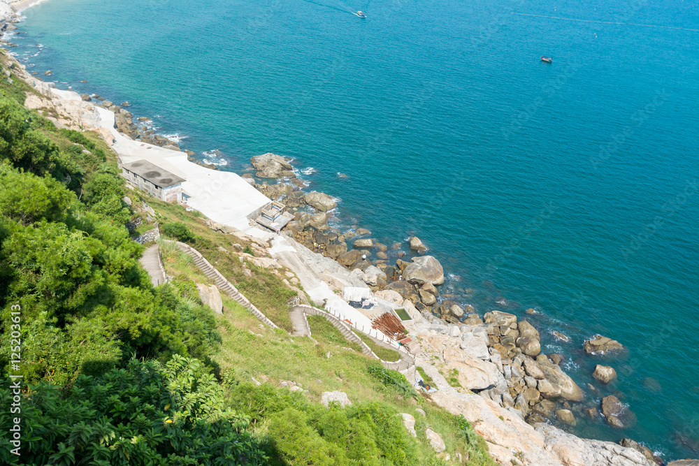 Coastline with green hill and blue sea at the Hailing island, yangjiang, China